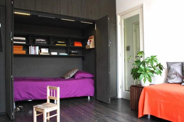 14914210-R3L8T8D-650-space-saver-beds-with-purple-bedding-and-built-in-bookshelves-also-cabinets-with-dark-wood-flooring-and-indoor-plant-plus-day-bed-bedding