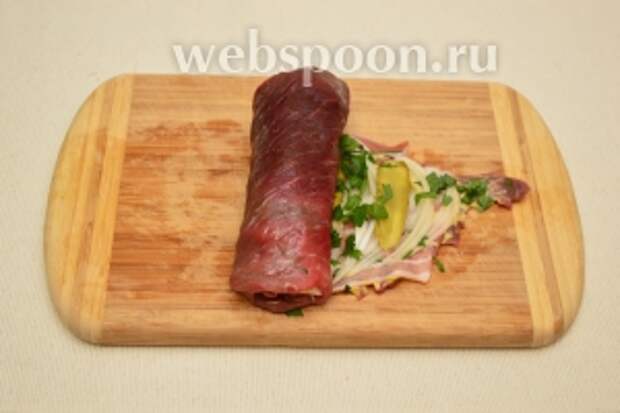 Аккуратно и плотно завернуть мясной пласт с начинкой в рулет.