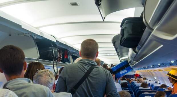 airline passengers luggage overhead compartment