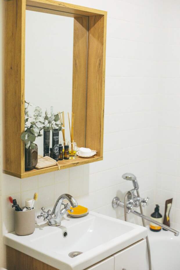 В ванной очень тесно, но светло и опрятно. Классная идея с деревянной полкой-рамкой вокруг зеркала