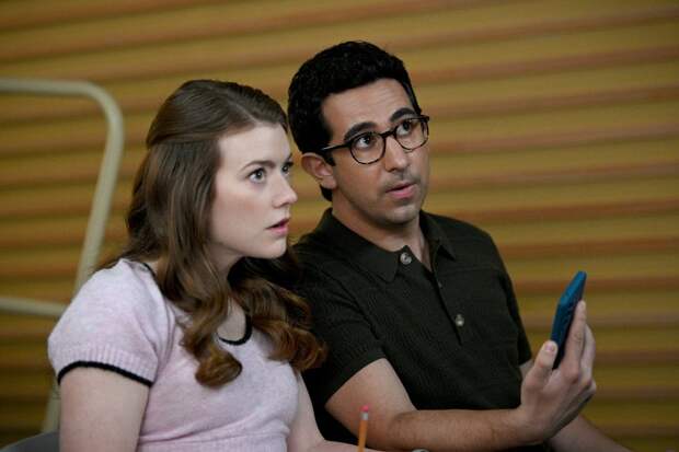 Phoebe and Rizwan looking shocked at something on the phone on The Irrational Season 2 Episode 16