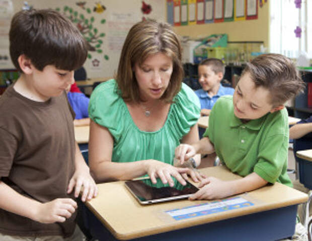 kids learning using tablet / ipad with teacher