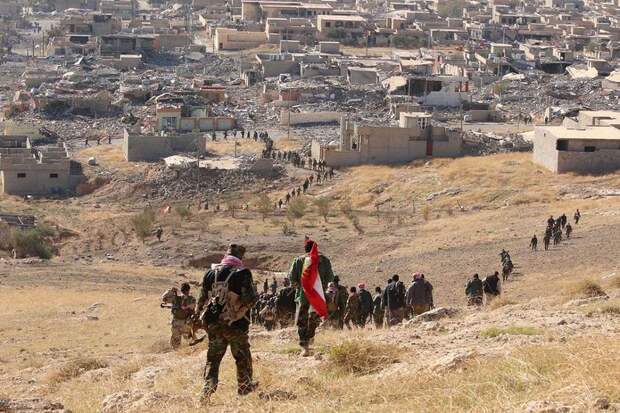Members of the Kurdish peshmerga forces gather in the town of Sinjar