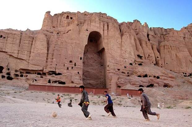 Afghan Boys Play Football in Front of Buddha of Bamyan