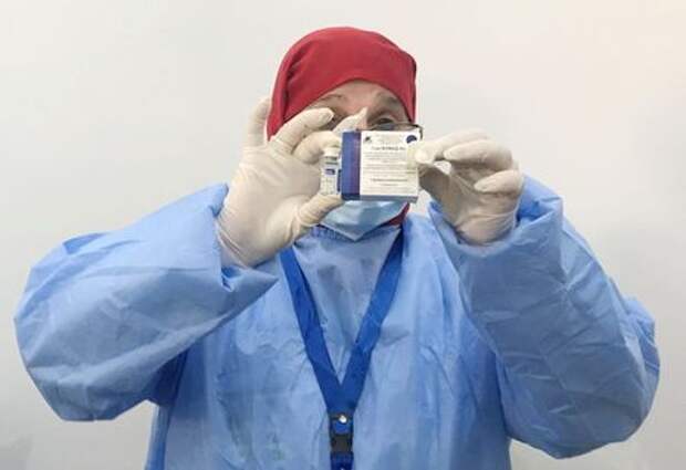 A healthcare worker holds a box and a vial of the Sputnik V vaccine against the coronavirus disease (COVID-19), during a national vaccination campaign, in Algiers, Algeria January 31, 2021. REUTERS/Abdelaziz Boumzar