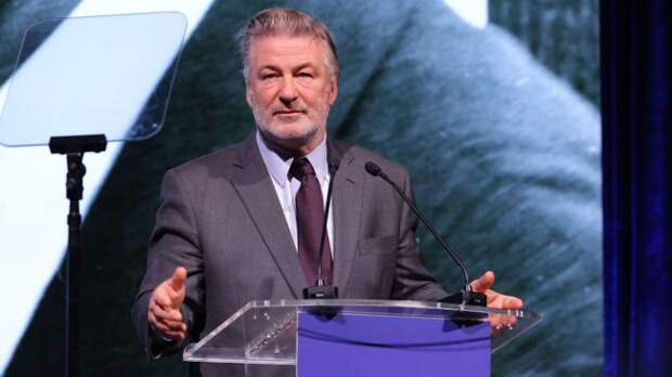 alec baldwin speaking at a podium