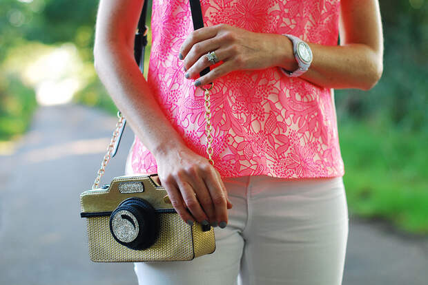 Camera bag and neon pink top