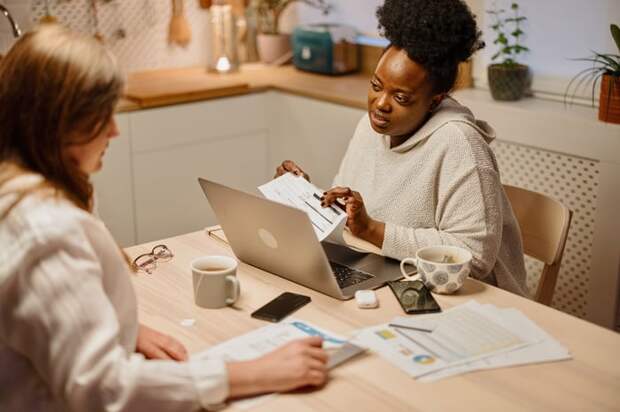Two adults looking at financial paperwork.