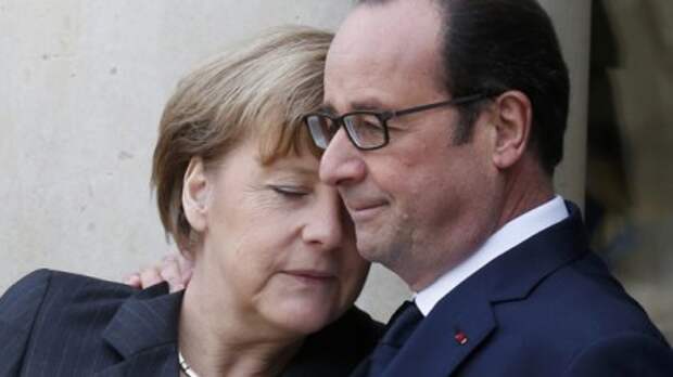 French President Hollande welcomes Germany's Chancellor Merkel as she arrives at the Elysee Palace before the solidarity marchin the streets of Paris