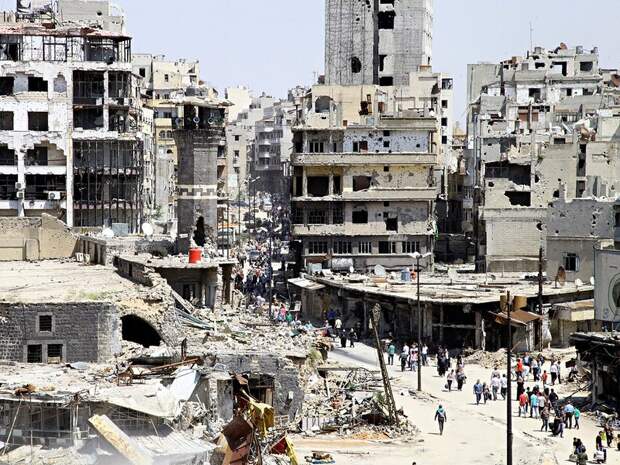 Residents arrive to inspect their homes, after the cessation of fighting between rebels and forces l