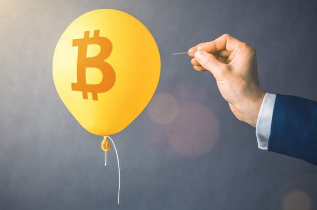 Balloon with bitcoin logo and man holding a needle