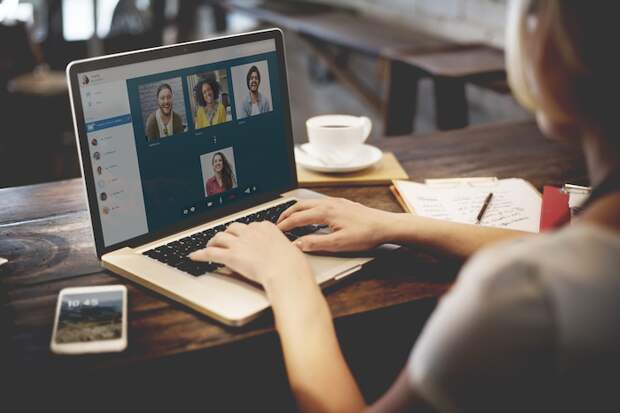 Woman sitting down at desk video chatting