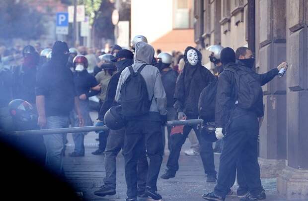 Masked protesters take part in a demonst