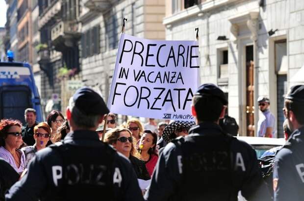 Demonstrators hold a banner reading in I