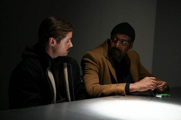 Alec sitting a table in an interrogation room with a suspect on The Irrational Season 2 Episode 1