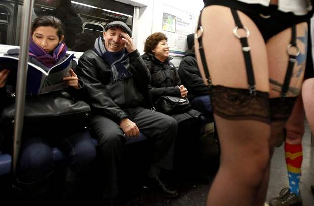 People watch as participants in the No Pants Subway Ride take the 6 train downtown in New York January 13, 2013. The event is an annual flash mob and occurs in different cities around the world, according to its organisers. REUTERS/Carlo Allegri (UNITED S
