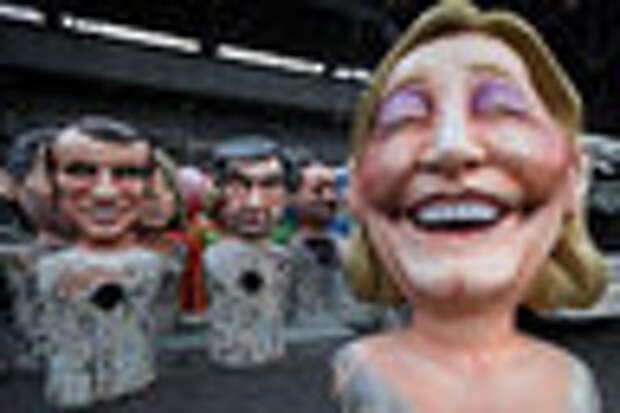 Giant figures of (L-R) Emmanuel Macron, head of the political movement En Marche !, or Onwards !, and candidate for the 2017 presidential election, Francois Fillon, former French prime minister, member of The Republicans political party and 2017 presidential candidate of the French centre-right, and French National Front leader Marine Le Pen, are seen during preparations for the carnival parade in Nice, France, February 2, 2017. REUTERS/Eric Gaillard