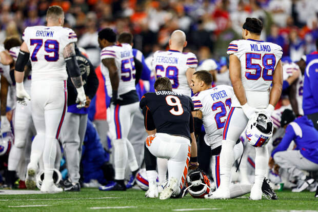 Joe Burrow kneeling with Bills players