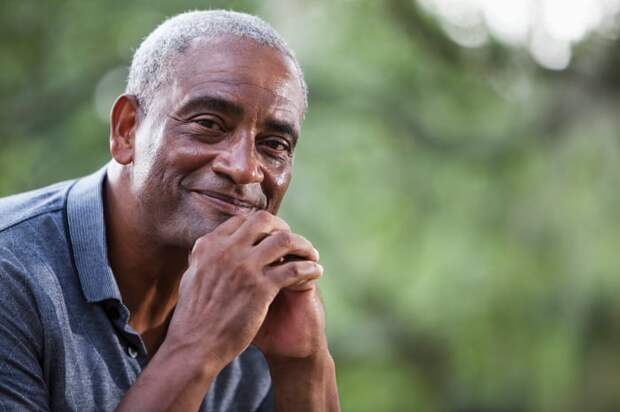 A smiling person outdoors.
