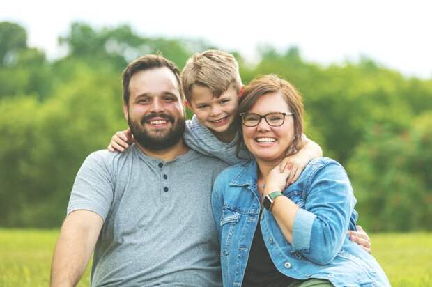 A family is shown, with one kid -- all smiling.