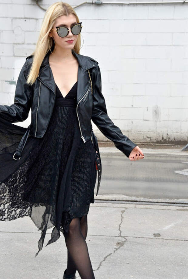 I am walking in  a black dress with a black leather jacket.