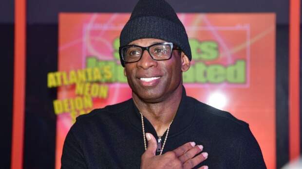Deion Sanders poses for a photo with Sports Illustrated.