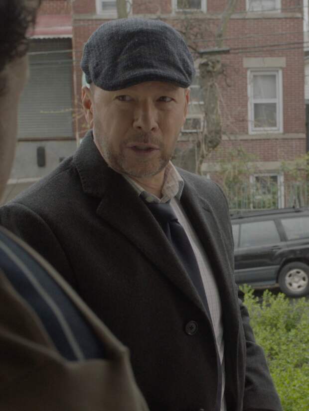 Danny and Baez talking to someone in a doorway on Blue Bloods Season 14 Episode 13