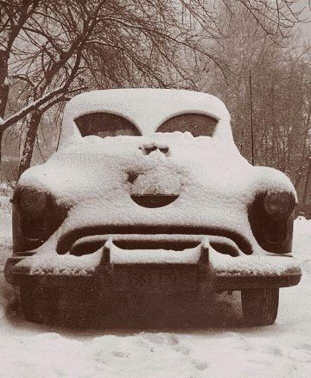 SNOW IN APRIL MAKES ME CRANKY:   "A snow-covered car looks unhappy with its plight after a 1952 storm."