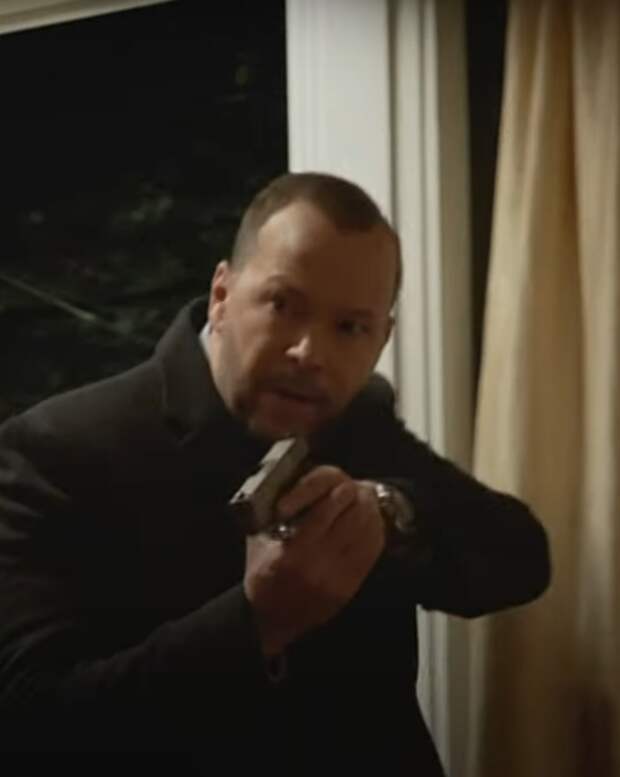 Danny in a house with his gun out on Blue Bloods Season 14 Episode 14