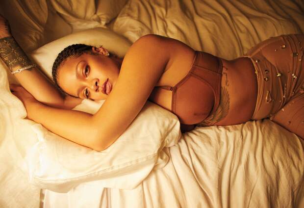 Miu Miu skirt; Savage X Fenty bra and bikini; Yvan Tufenkjian earring (top), Harry Kotlar stud (bottom); Le Vian bracelet. Fenty Beauty Slip Shine Sheer Shiny Lipstick in Goji Gang ($22)