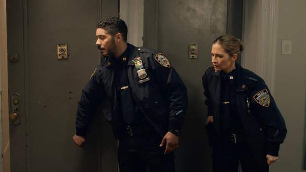 Eddie and Badillo approach an apartment where shots have been fired on Blue Bloods Season 14 Episode 11