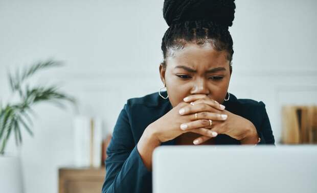 Concerned person looking at computer.