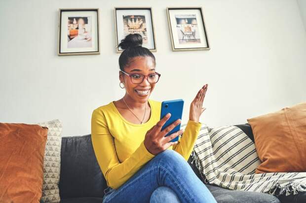 Happy person looking at smartphone.