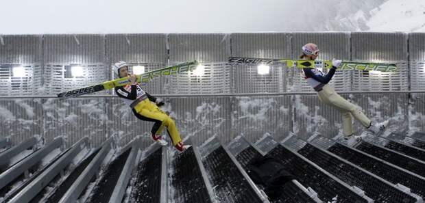 Simon Ammann of Switzerland and Austria's Martin Koch walk down the stairs for their practice jump on the Large Hill HS134 at the Nordic Ski World Championships in Oslo on March 1, 2011. (REUTERS / Petr Josek)