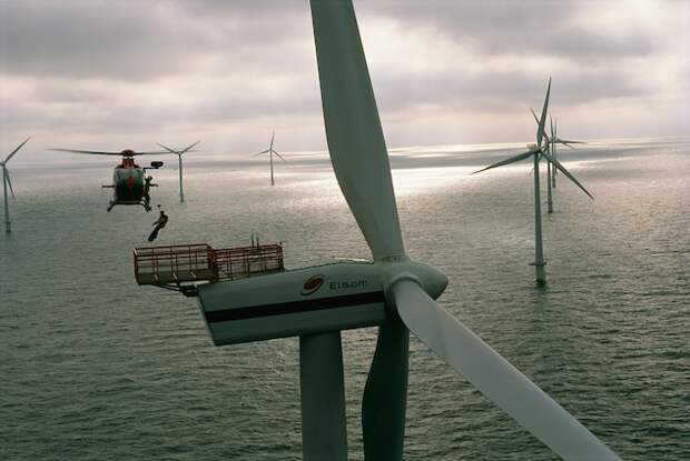 A helicopter lowers a technician to maintain the Horns Rev wind farm in Esbjerg, Denmark. When this photo appeared in the August 2005 issue, wind generated 20 percent of all electricity in Denmark.