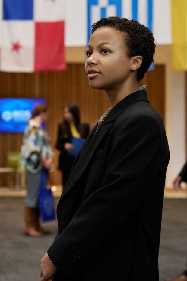 Harper arrives at a panel on Industry Season 3 Episode 3.