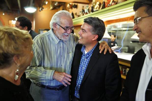 U.S. Rep. Cory Gardner, center right, who is running for the U.S. Senate, talks with supporter Don Trujillo during a meeting and a press conference with state Republican Hispanics, at a Mexican restaurant in Aurora, Colo., on Wednesday, Sept. 24, 2014. (AP Photo/Brennan Linsley)