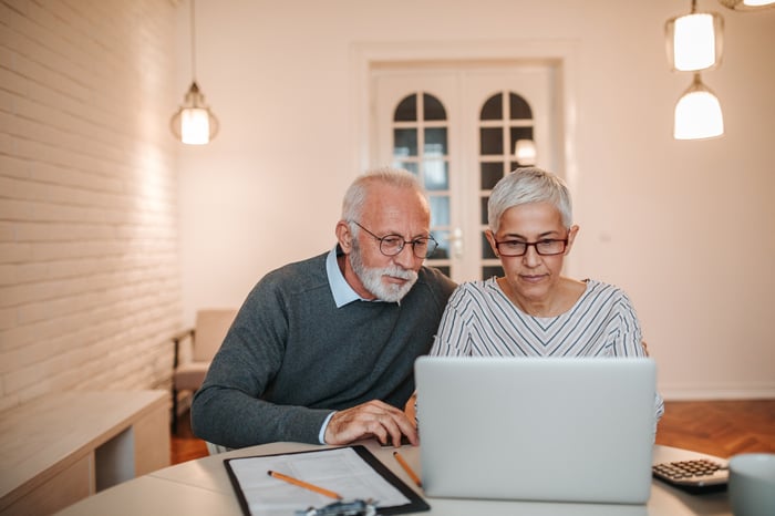 Two people at a laptop.