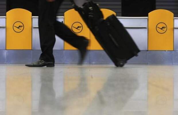A passenger walks past Lufthansa ticket counters at Frankfurt airport February 11, 2014. REUTERS/Ralph Orlowski