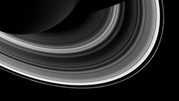 Among the interplay of Saturn's shadow and rings, Mimas, which appears in the lower-right corner of the image, orbits Saturn as a set of the ever-intriguing spokes appear in the B ring. 