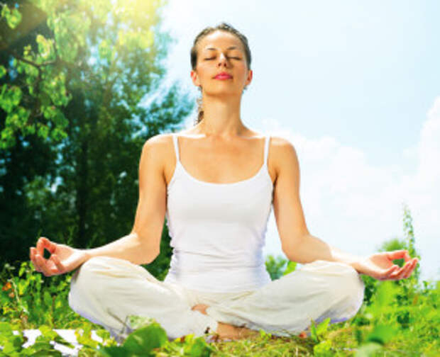 Young Woman doing Yoga Exercises Outdoor. Beautiful Girl practic