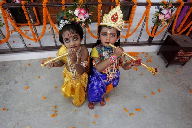 Children dressed up as Hindu Lord Krishna pose during Janmashtami festival celebrations in Agartala