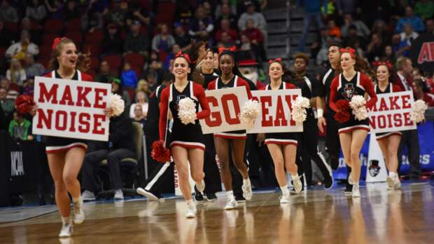 Austin Peay cheerleaders run onto the basketball court.