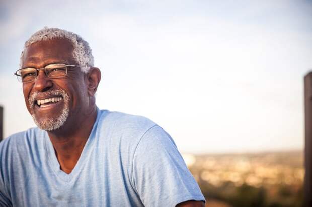 A smiling person outdoors.